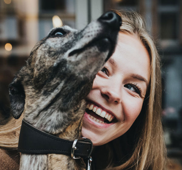 girl laughing with dog